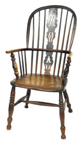 A 19thC oak and elm Windsor chair, with a carved splat, solid saddle seat, raised on ring turned legs united by an H framed stretcher, 58cm wide.