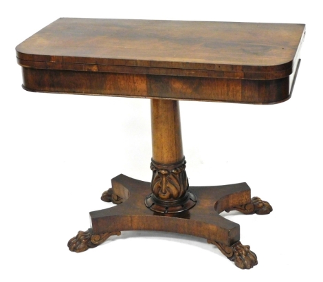 A Regency rosewood fold over card table, raised on a turned and lappet carved column and quatrefoil base terminating in lion's paw feet, 72cm high, 89cm wide, 44cm deep.