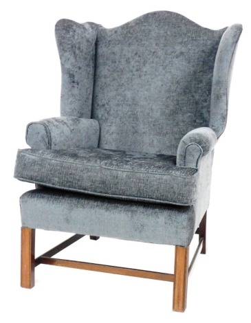 A Chippendale style mahogany wing armchair, upholstered in grey draylon, 80cm wide. The upholstery in this lot does not comply with the 1988 (Fire & Fire Furnishing) Regulations, unless sold to a known exporter or upholsterer it will be cut from the fram