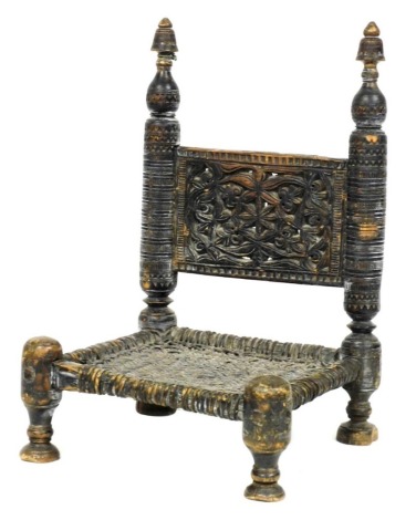 A 19thC Afghan chair, with a foliate carved back panel on dog tooth and ring turned supports, low woven cane seat, raised on turned legs, 45cm wide.