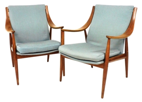 A pair of Finn Juhl teak lounge chairs, model 148, designed by Peter Hvidt and Orla Molgaard Nielsen, 67cm wide. The upholstery in this lot does not comply with the 1988 (Fire & Fire Furnishing) Regulations, unless sold to a known exporter or upholsterer 