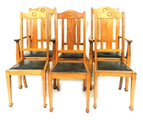 A set of six Victorian oak dining chairs, with button green leather seats, raised on tapering square legs, comprising a pair of carvers and four single chairs. 