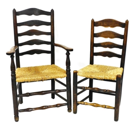 A 19thC country made ash ladder back armchair, with rush seat on turned tapering legs, and a matching side chair.