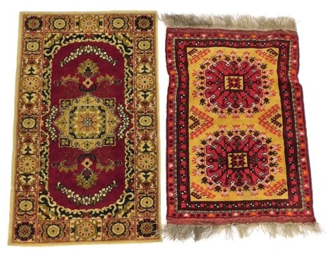 Two Eastern red ground rugs, 107cm x 66cm, and 65cm x 94cm.