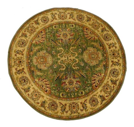 A European wool green ground circular rug, florally decorated centrally, within multiple floral borders, 168cm diameter.