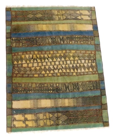 A Caucasian rug, decorated with vertical panels in green, blue and yellow, within a geometric border, 178cm x 135cm.