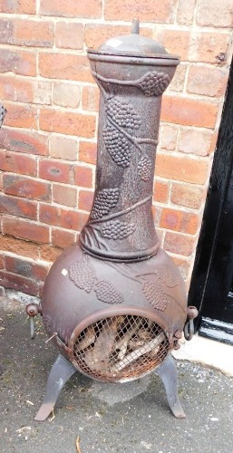 A cast iron garden chiminea, decorated with vines, 116cm high.