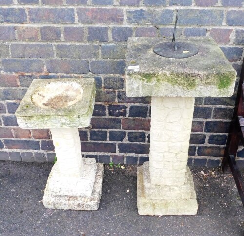 A composition bird bath, 63cm high, and a similar sundial, 107cm high.