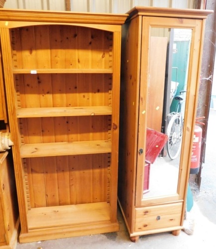 A pine open bookcase, with five shelves, 184cm high, 92cm wide, 37cm deep, and a pine single wardrobe with mirrored door, 184cm high, 56cm wide, 59cm deep.