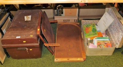 A Chad Valley bagatelle board, desk easel, metal trunk, and a suitcase.