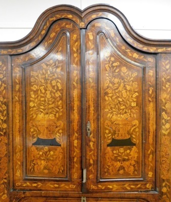 A 18thC Dutch marquetry corner cabinet, with fixed swan neck pediment, raised above heavily carved shelves and cupboard beneath, profusely decorated with leaves and flowers with a lower geometric inlay, fronted by two elaborate designed doors, 243cm high, - 4