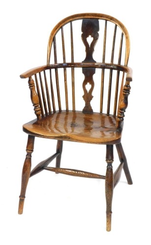 A early 19thC ash and elm Windsor low back armchair, with pierced vase splat and turned legs with H frame stretcher, the seat stamped GRANTHAM.