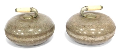 A pair of Edwardian Ailsa Craig blue hone polished granite curling stones, with reversible nickel mounted ivory handles, 29cm diameter.