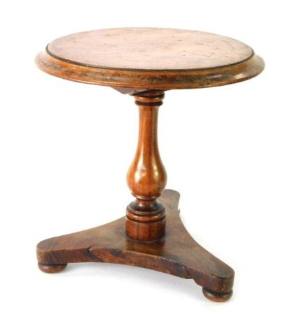 A Victorian flame mahogany apprentice or tradesman sample miniature table, with moulded top, baluster stem, trefoil base and bun feet, 22cm high, 22cm diameter.