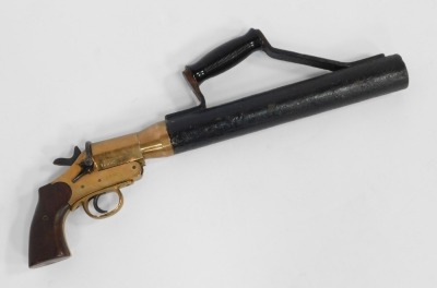 An early 20thC Schermuly's line throwing pistol, being an implement used for lifesaving of those in vessels in distress, patent number 563324, Serial No.12892, bears proof marks, with mahogany handle and iron barrel, 50cm wide.