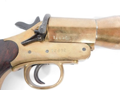 An early 20thC Schermuly's line throwing pistol, being an implement used for lifesaving of those in vessels in distress, patent number 563324, Serial No.12892, bears proof marks, with mahogany handle and iron barrel, 50cm wide. - 3