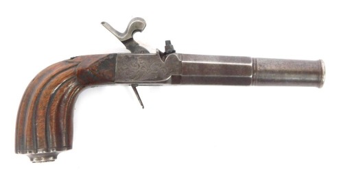 An early 19thC box lock percussion pocket pistol with detachable part turned and octagonal twist barrel, engraved lock, concealed trigger and carved walnut handle, 23cm.