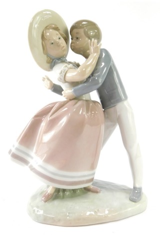 A Lladro figure group of a girl and boy dancing, 25cm high.