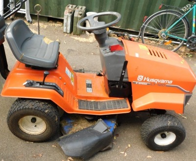 A Husqvarna six speed LT120 petrol ride-on mower.