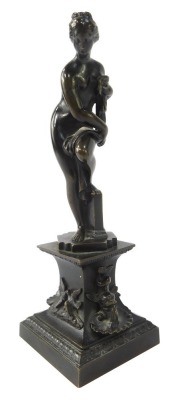 After the Antique. A bronze figure of a maiden, carrying robe on stepped base with swallows, 21cm high.