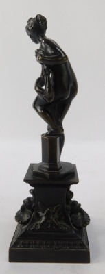 After the Antique. A bronze figure of a maiden, carrying robe on stepped base with swallows, 21cm high. - 2