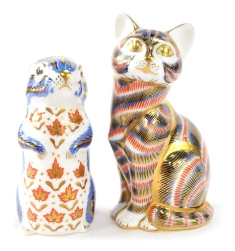Two Royal Crown Derby paperweights, comprising cat, 12cm high, and otter, 10cm high, each with gold stopper. (2)