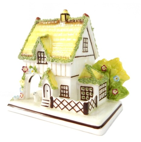 A Coalport Master's House ceramic cottage, 10cm high.