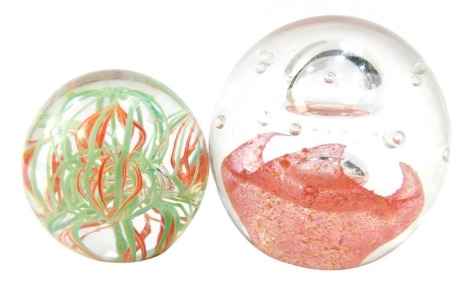 Two Art glass paperweights, comprising a two tier pink swirl and bubble, 9cm high, and a green and pink swirl, 7cm high. (2)