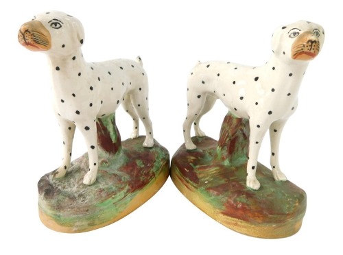 A pair of Staffordshire style Dalmatians, each on a mottled base, unmarked, 15cm high.