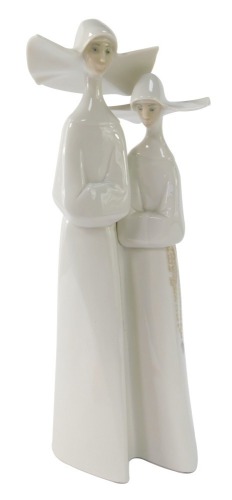 A Lladro figure group of two Nuns, 32cm high.