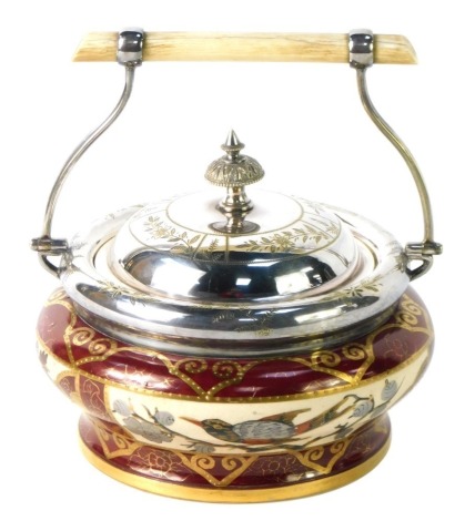 A Victorian ceramic biscuit jar, with silver plated top and swing handle, on a red and gilt Robin decorated body, 10cm high.