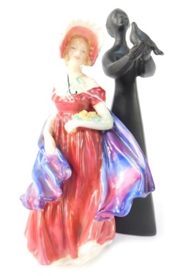 Two Royal Doulton figures, comprising Peace, matt black, 21cm high, and Lady April, 18cm high. (2)