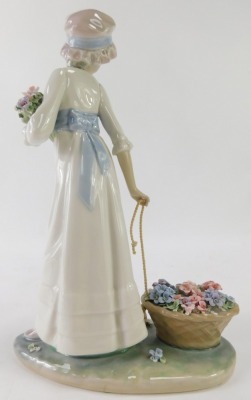 A Lladro porcelain figure group of a lady carrying basket of flowers, 28cm high. - 3