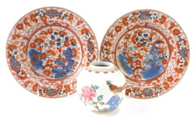 A pair of 19thC Chinese Imari soup plates, 23cm diameter, and a Chinese ginger jar, 10cm high. (3)