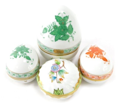 Four Herend of Hungary porcelain trinket dishes, two formed as eggs, in green painted Apponyi or Chinese bouquet pattern, the other orange, a large domed top egg, and a floral butterfly design trinket dish. (4)