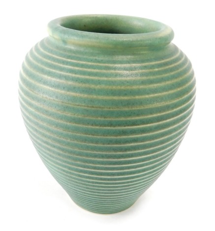 A Motto ware ribbed studio pottery vase, on a green ground, 21cm high.