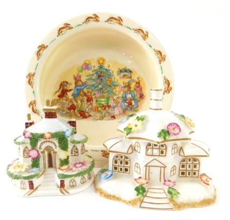 A group of ceramics, comprising two Coalport cottages, Keepers Cottage, and The Parasol House, and a Royal Doulton Bunnykins bowl, 19cm diameter. (3)