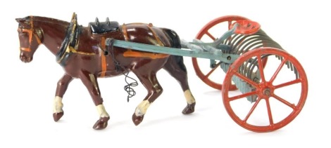 A Britains lead figure of a Shire Horse pulling harrows.