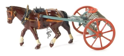A Britains lead figure of a Shire Horse pulling harrows.