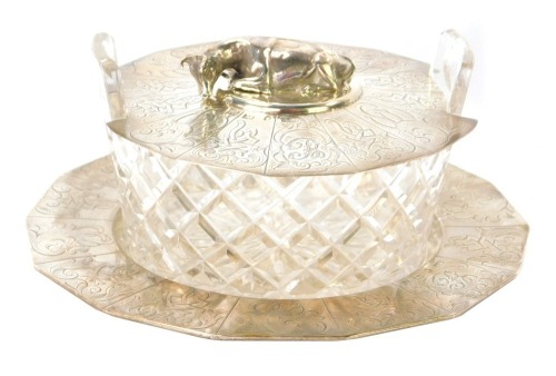 A Victorian silver butter dish, with hexagonal base with crested panels, bearing the initial B, London, with cut glass bowl, and engraved lid with applied cow motif, Henry Wilkinson & Co, Sheffield 1844, 18cm diameter.