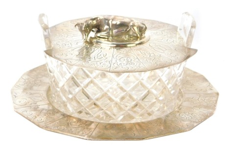 A Victorian silver butter dish, with hexagonal base with crested panels, bearing the initial B, London, with cut glass bowl, and engraved lid with applied cow motif, Henry Wilkinson & Co, Sheffield 1844, 18cm diameter.