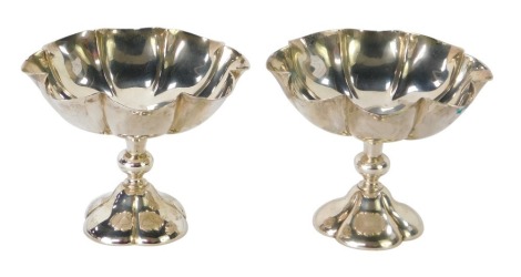 A pair of Edward VII silver pedestal bon-bon dishes, each numbered 73901, London 1903, maker H W & Co Ltd, 9 oz gross, 9cm high.