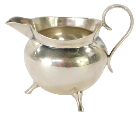 A Victorian Mappin & Webb silver milk jug, of plain cauldron design on tripod base, Sheffield 1896, 2 ¼oz.