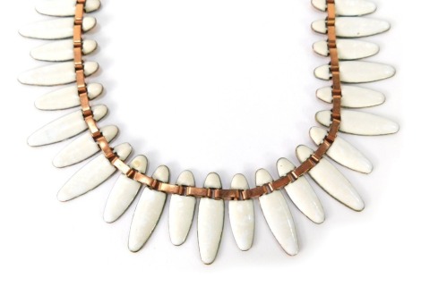 A Matisse brass and enamel necklace, with elongated white enamel teeth links, the clasp stamped Matisse with drop pendant, 47cm long.