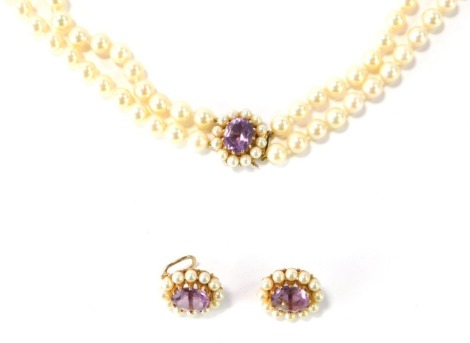 A cultured pearl jewellery suite, comprising two strand graduated necklace and earrings, the necklace, 82cm long overall, the beads 5mm, with an amethyst and seed pearl oval clasp, 2cm wide, the amethyst in claw setting, in 9ct gold, with matching earring