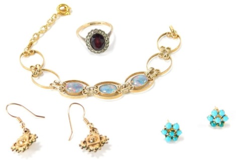 A group of 9ct gold and other jewellery, comprising a 9ct gold and silver dress ring, with oval garnet and paste stone set border, size P ½, pair of turquoise set plated stud earrings, Eastern inspired gold plated drop earrings, and a silver and opal brac