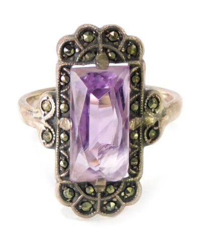 An amethyst and marcasite Art Deco style dress ring, the rectangular amethyst surround by marcasite stones, on a white metal band, stamped SIL, 3.9g all in, boxed.