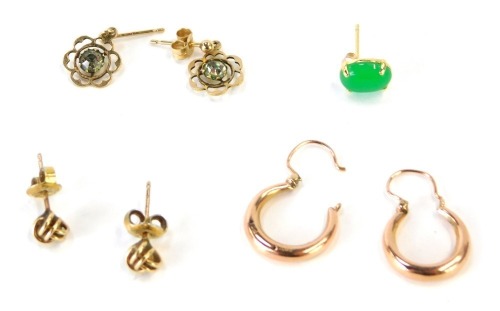 A group of earrings, comprising a pair of 9ct rose gold hoop earrings, a pair of 9ct cluster stud earrings, a pair of 9ct gold daisy drop earrings, and a single jade earring, 3.6g all in. (a quantity)