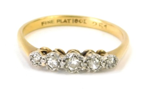 An 18ct gold and plat diamond five stone dress ring, set with five illusion set diamonds in platinum, on a yellow metal band, size Q, 2.5g all in.