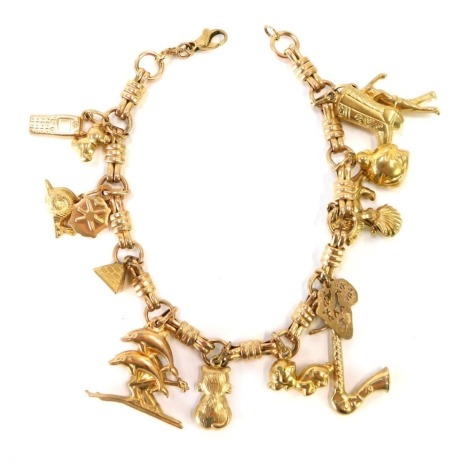 A 9ct gold charm bracelet, with fancy link two loop and three row joined chain, with various charms including boot, golfer, shell, lion, trumpet, dog, cat, dolphin, ladybird, snail and phone, all yellow metal some marked 9ct, 19cm long, 18.3g.